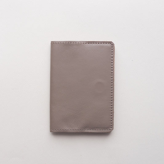 Cappuccino smooth leather passport cover Doco closed on a light background